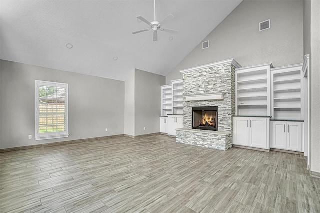 517 N Quail Run, Altus, OK 73521 - unfurnished living room with ceiling fan, high vaulted ceiling, light wood-style flooring, and a fireplace