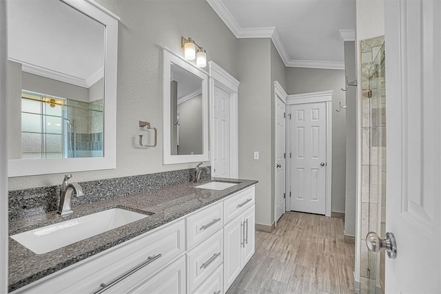 517 N Quail Run, Altus, OK 73521 - full bathroom featuring crown molding, double vanity, wood finished floors, and tiled shower