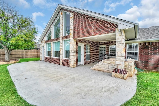517 N Quail Run, Altus, OK 73521 - rear view of house featuring brick siding and a patio