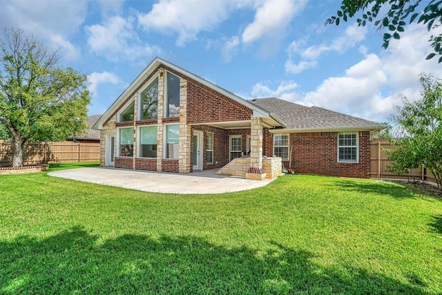 517 N Quail Run, Altus, OK 73521 - back of house featuring a patio area, a fenced backyard, brick siding, and roof with shingles