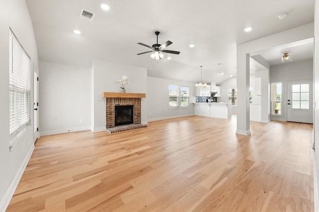 17717 Boling Farm Rd, Edmond, OK 73012 - unfurnished living room with light wood-style flooring, a ceiling fan, a chandelier, a brick fireplace, and recessed lighting
