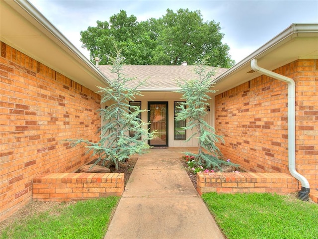 2004 Tanglewood Dr, Edmond, OK 73013 - entrance to property with brick siding and a shingled roof