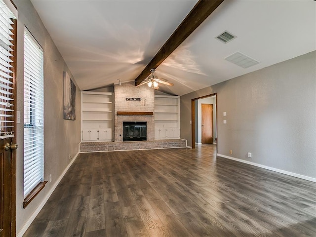 2004 Tanglewood Dr, Edmond, OK 73013 - unfurnished living room with a ceiling fan, dark wood finished floors, a brick fireplace, and built in features
