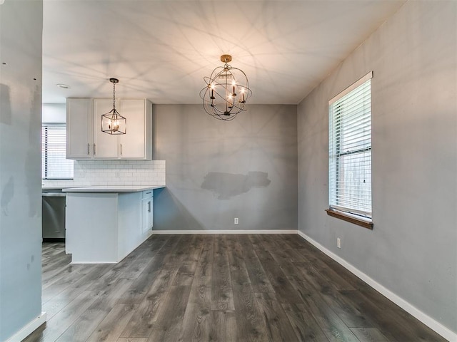 2004 Tanglewood Dr, Edmond, OK 73013 - unfurnished dining area with a chandelier and dark wood-style flooring