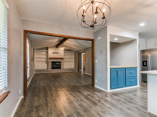 2004 Tanglewood Dr, Edmond, OK 73013 - unfurnished living room featuring dark wood finished floors, built in features, a fireplace, and a ceiling fan