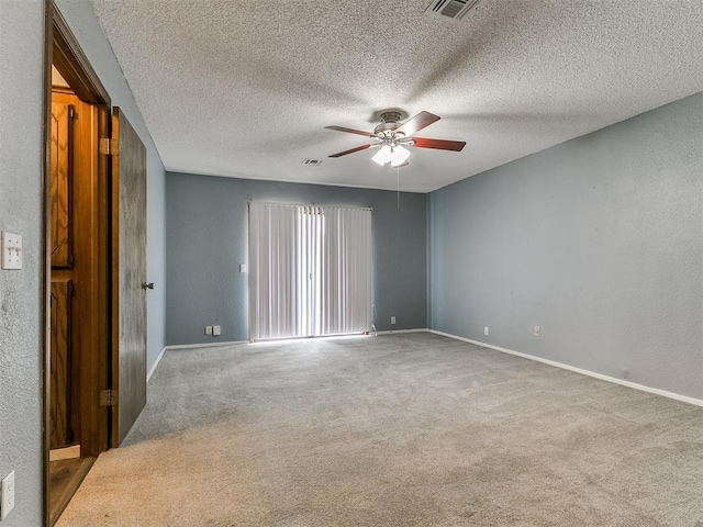 2004 Tanglewood Dr, Edmond, OK 73013 - carpeted spare room with ceiling fan and a textured ceiling