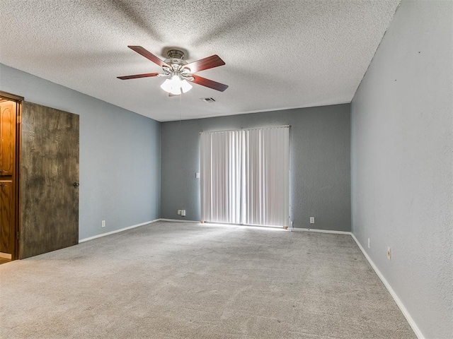 2004 Tanglewood Dr, Edmond, OK 73013 - carpeted empty room with ceiling fan and a textured ceiling