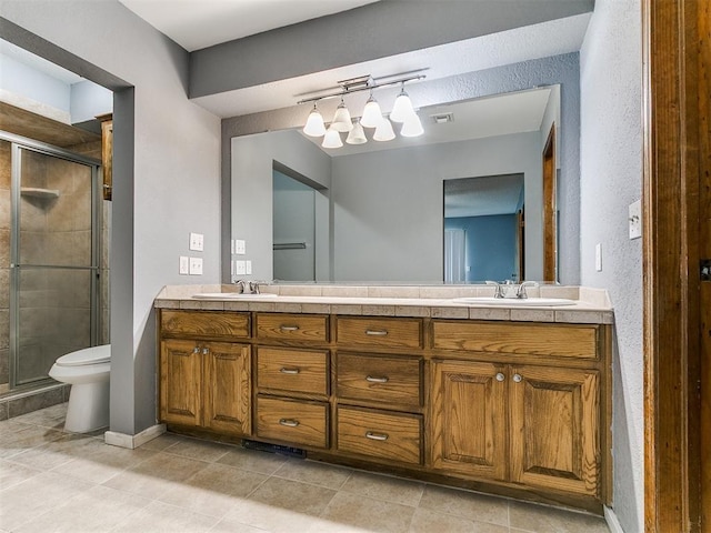 2004 Tanglewood Dr, Edmond, OK 73013 - full bathroom with double vanity, a shower stall, and tile patterned floors