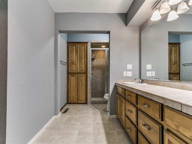 2004 Tanglewood Dr, Edmond, OK 73013 - full bath featuring a stall shower, vanity, tile patterned flooring, and a chandelier