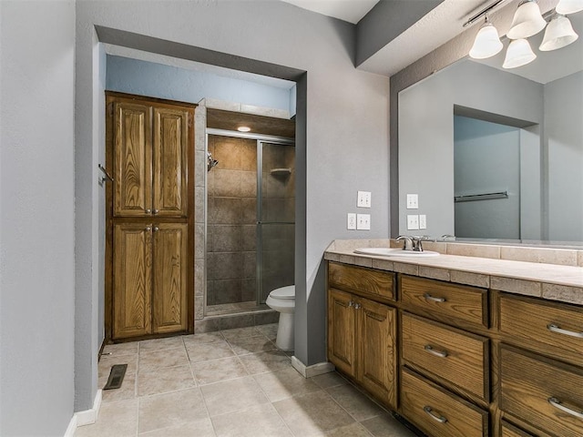 2004 Tanglewood Dr, Edmond, OK 73013 - bathroom featuring a shower stall, vanity, and tile patterned flooring