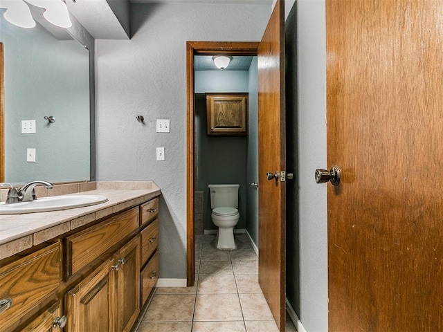 2004 Tanglewood Dr, Edmond, OK 73013 - bathroom with vanity, tile patterned flooring, and a textured wall