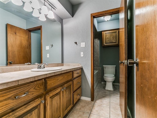 2004 Tanglewood Dr, Edmond, OK 73013 - full bath with vanity, tile patterned floors, a bathtub, and a textured wall