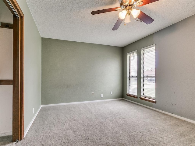 2004 Tanglewood Dr, Edmond, OK 73013 - carpeted empty room featuring a textured ceiling, ceiling fan, and a textured wall