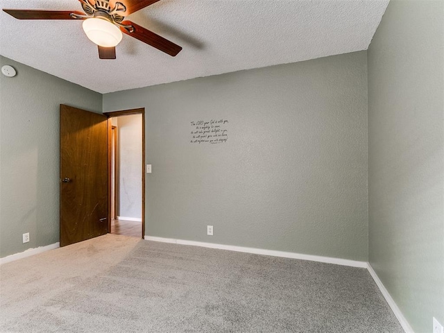2004 Tanglewood Dr, Edmond, OK 73013 - carpeted spare room with ceiling fan, a textured ceiling, and a smoke detector