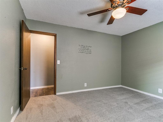 2004 Tanglewood Dr, Edmond, OK 73013 - empty room with carpet flooring, a textured ceiling, and a ceiling fan