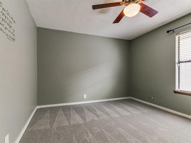 2004 Tanglewood Dr, Edmond, OK 73013 - empty room with carpet flooring, a textured ceiling, and a ceiling fan