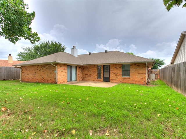 2004 Tanglewood Dr, Edmond, OK 73013 - back of property featuring brick siding, a patio area, and a fenced backyard