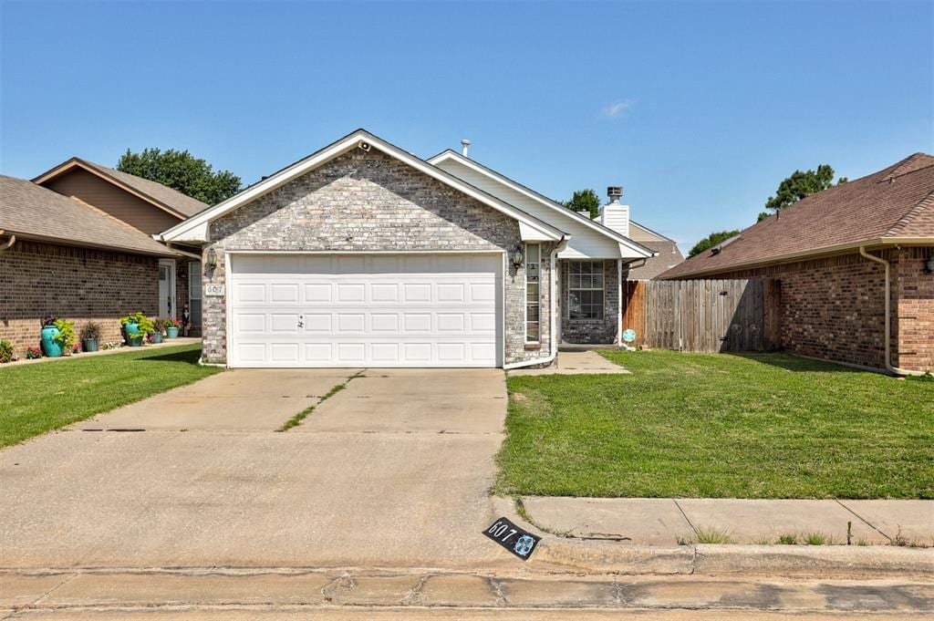 607 Stoneridge Dr, Moore, OK 73160 - ranch-style house featuring a garage, driveway, and brick siding