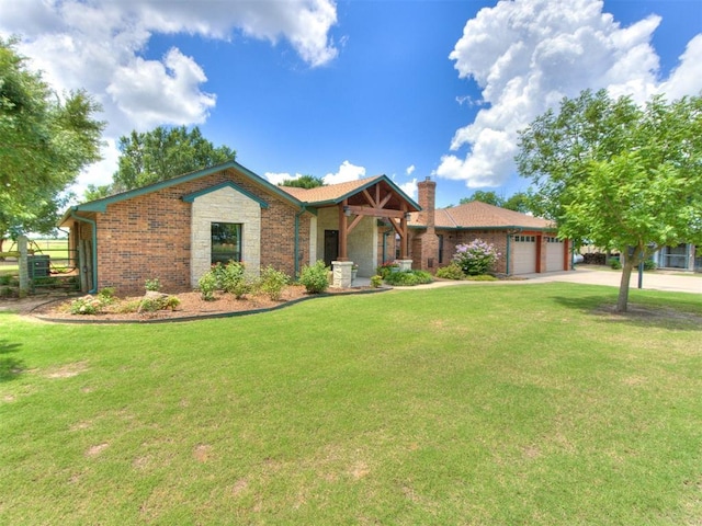 1616 E Cottonwood Rd, Goldsby, OK 73093 - ranch-style home with a chimney, a front yard, brick siding, and a garage