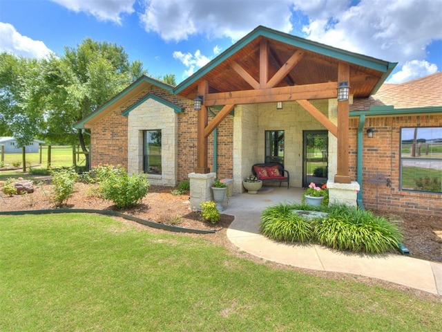 1616 E Cottonwood Rd, Goldsby, OK 73093 - view of front of house featuring a front lawn, stone siding, roof with shingles, and brick siding