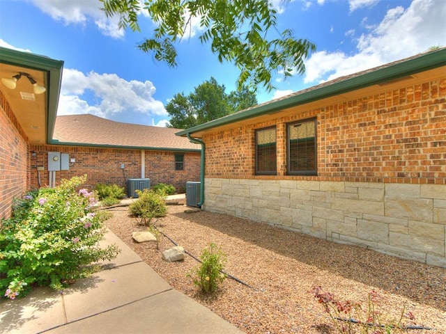 1616 E Cottonwood Rd, Goldsby, OK 73093 - view of property exterior with brick siding and a cooling unit