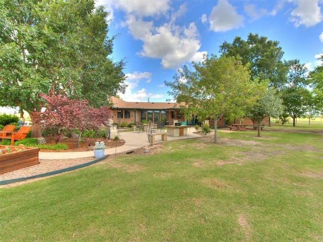 1616 E Cottonwood Rd, Goldsby, OK 73093 - view of green lawn featuring a vegetable garden