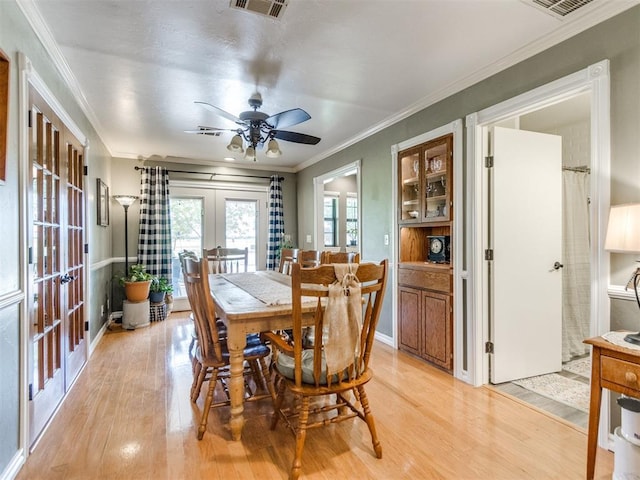 1616 E Cottonwood Rd, Goldsby, OK 73093 - dining room featuring french doors, light wood finished floors, ceiling fan, and crown molding