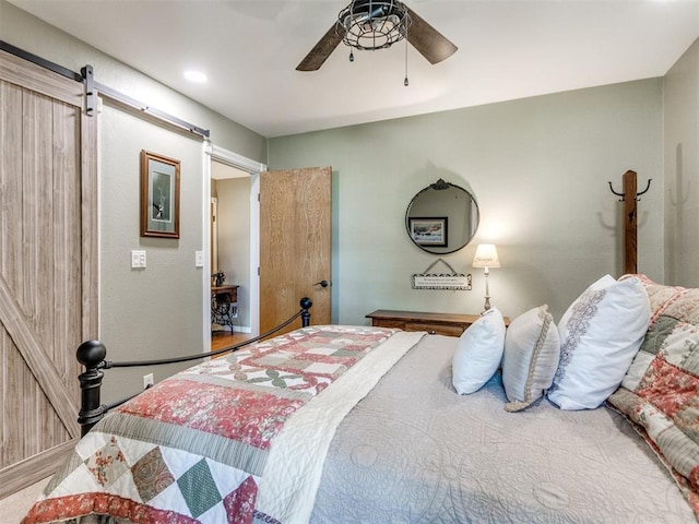 1616 E Cottonwood Rd, Goldsby, OK 73093 - bedroom with a barn door and a ceiling fan