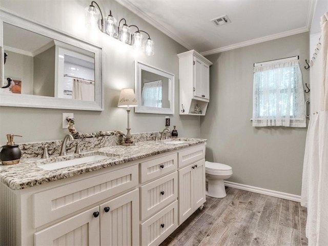 1616 E Cottonwood Rd, Goldsby, OK 73093 - full bath with double vanity, wood finished floors, and crown molding