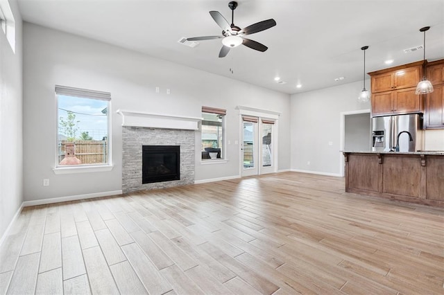 9233 NW 91st St, Yukon, OK 73099 - unfurnished living room with ceiling fan, light wood-type flooring, recessed lighting, and a fireplace