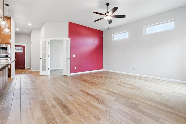 9233 NW 91st St, Yukon, OK 73099 - unfurnished living room with a ceiling fan, light wood-type flooring, french doors, and recessed lighting