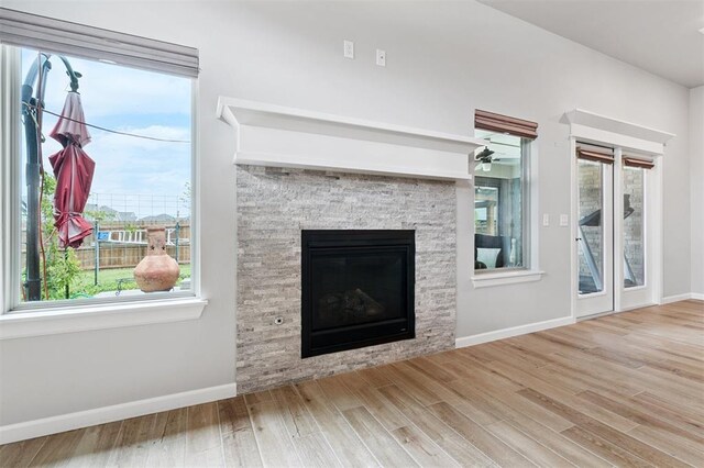 9233 NW 91st St, Yukon, OK 73099 - unfurnished living room with wood finished floors and a fireplace