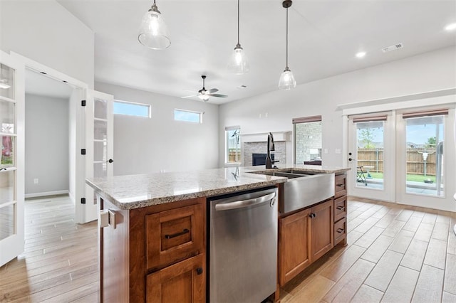 9233 NW 91st St, Yukon, OK 73099 - kitchen featuring stainless steel dishwasher, light wood-type flooring, brown cabinets, pendant lighting, and recessed lighting