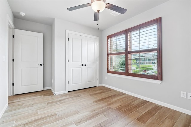 9233 NW 91st St, Yukon, OK 73099 - unfurnished bedroom featuring light wood-style flooring, a closet, and ceiling fan