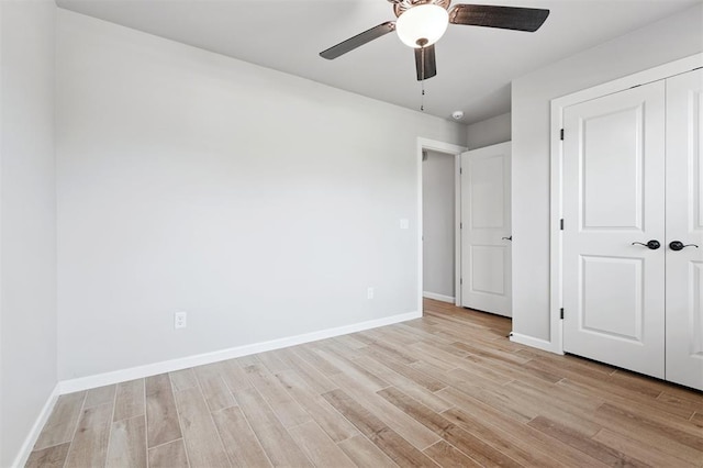 9233 NW 91st St, Yukon, OK 73099 - unfurnished bedroom featuring light wood finished floors, a closet, and ceiling fan