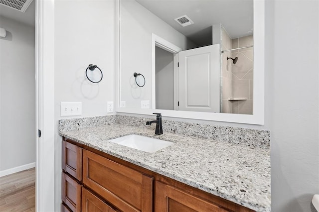 9233 NW 91st St, Yukon, OK 73099 - full bathroom featuring vanity, wood finished floors, and a shower