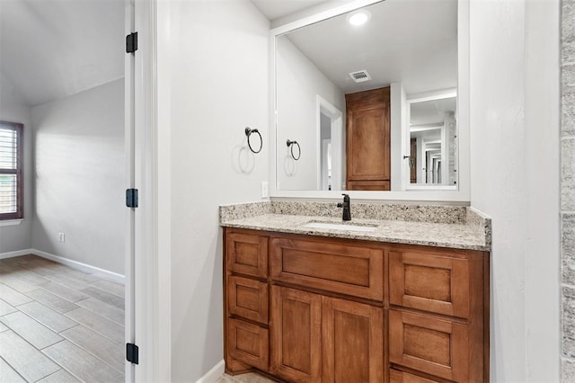 9233 NW 91st St, Yukon, OK 73099 - bathroom featuring vanity and lofted ceiling