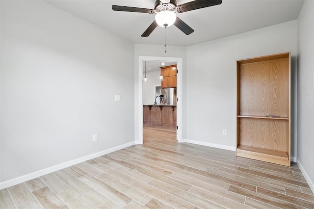 9233 NW 91st St, Yukon, OK 73099 - empty room featuring light wood finished floors and ceiling fan