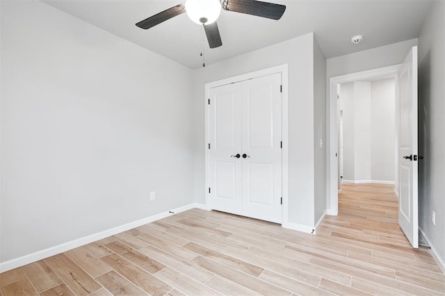 9233 NW 91st St, Yukon, OK 73099 - unfurnished bedroom featuring light wood-style floors, a closet, and a ceiling fan