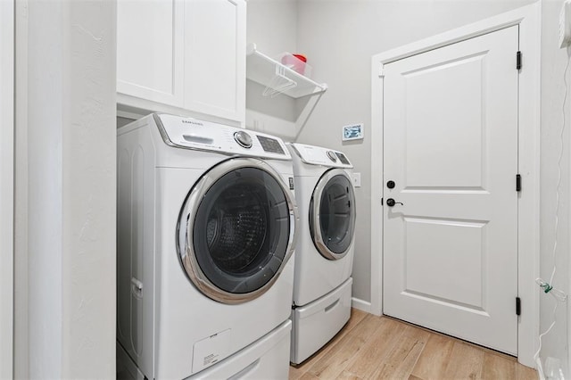 9233 NW 91st St, Yukon, OK 73099 - laundry room with washer and clothes dryer, light wood-style flooring, and cabinet space