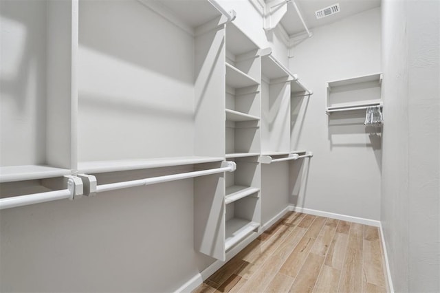 9233 NW 91st St, Yukon, OK 73099 - walk in closet featuring wood finished floors