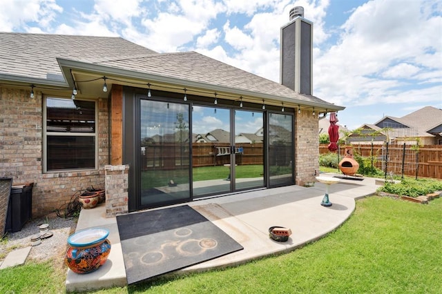 9233 NW 91st St, Yukon, OK 73099 - rear view of property featuring a shingled roof, a patio, a chimney, and brick siding