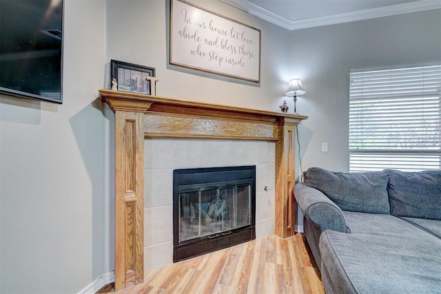 2209 Cedar Pointe Ct, Edmond, OK 73003 - living area with a tile fireplace, ornamental molding, and wood finished floors