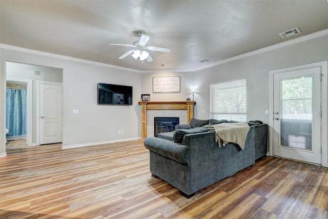 2209 Cedar Pointe Ct, Edmond, OK 73003 - living area with light wood-style floors, ceiling fan, crown molding, and a fireplace