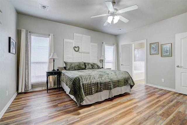 2209 Cedar Pointe Ct, Edmond, OK 73003 - bedroom with wood finished floors, a ceiling fan, and ensuite bath
