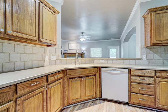 2209 Cedar Pointe Ct, Edmond, OK 73003 - kitchen featuring white dishwasher, crown molding, a ceiling fan, brown cabinetry, and light countertops