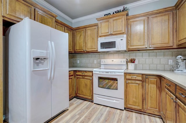 2209 Cedar Pointe Ct, Edmond, OK 73003 - kitchen featuring white appliances, light countertops, decorative backsplash, brown cabinetry, and crown molding