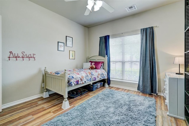 2209 Cedar Pointe Ct, Edmond, OK 73003 - bedroom with wood finished floors and a ceiling fan