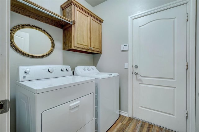 2209 Cedar Pointe Ct, Edmond, OK 73003 - laundry area with washer and dryer, cabinet space, and wood finished floors
