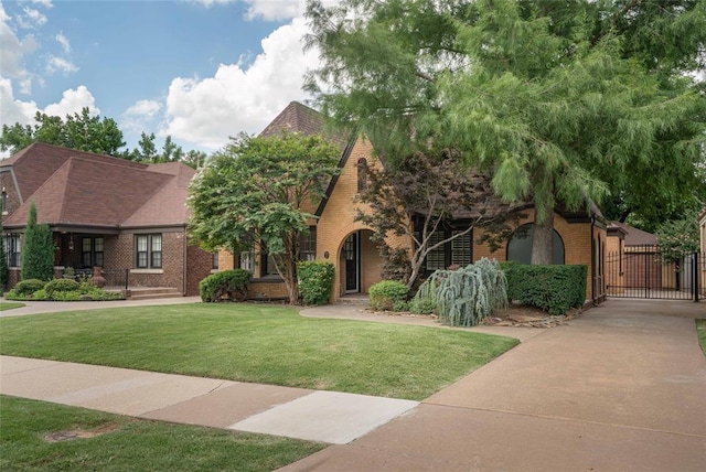 225 NW 35th St, Oklahoma City, OK 73118 - view of front of home featuring a gate, brick siding, and a front lawn